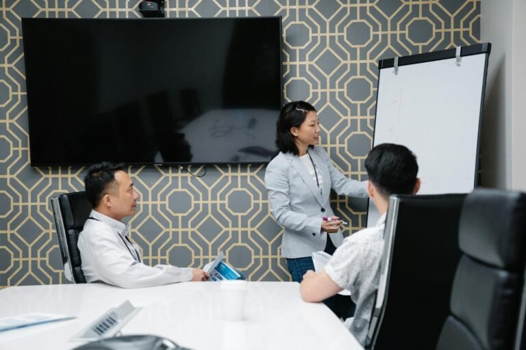 A professional conducting a presentation in a modern office space with colleagues engaged.